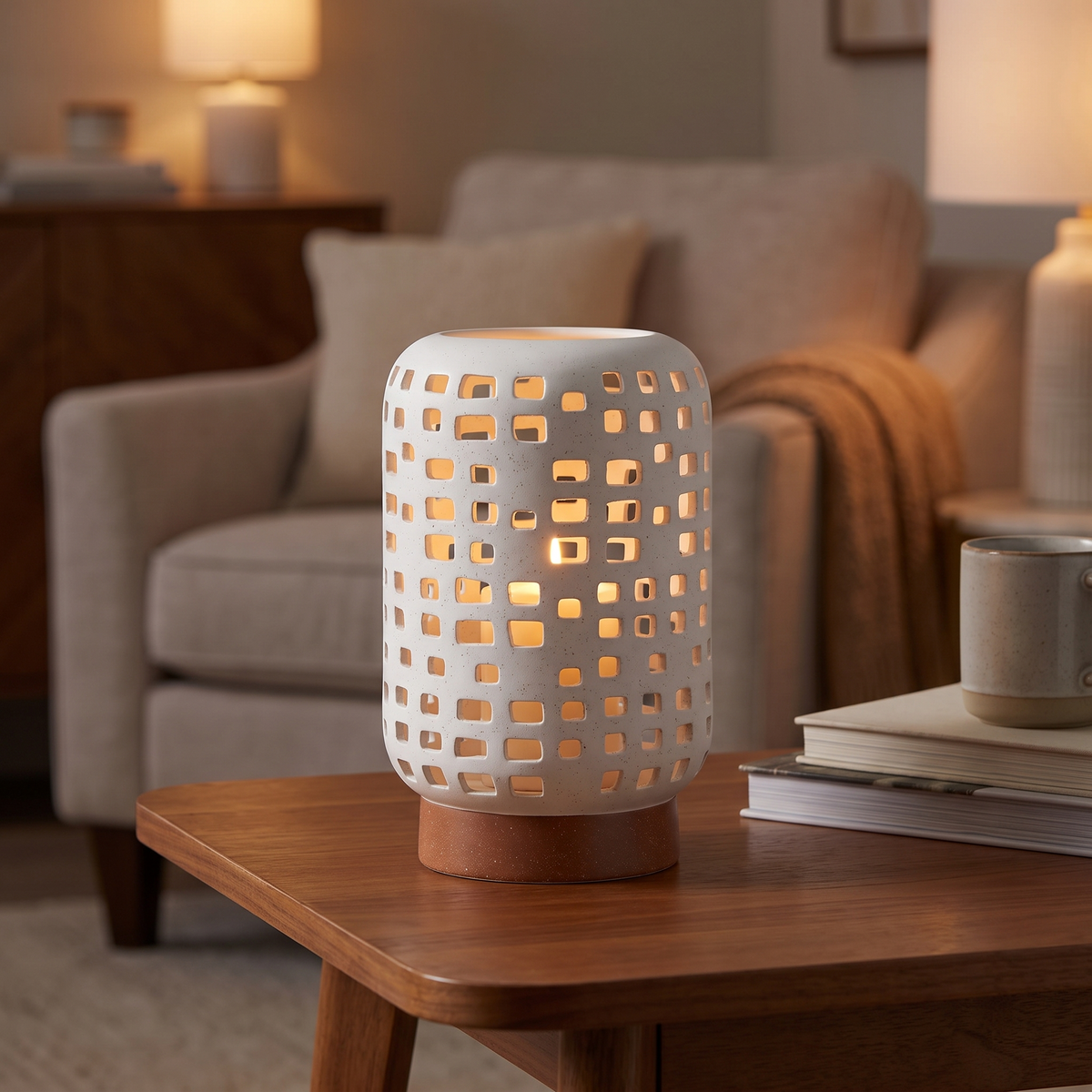 White ceramic lantern candle holder glowing on a side table